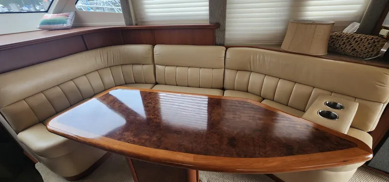  Yacht Photos Pics Luxurious interior of 2004 Silverton 48 Convertible yacht with plush seating and polished wood table.