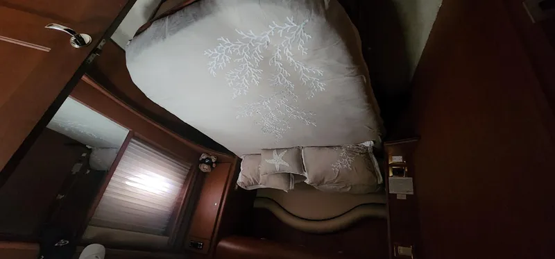  Yacht Photos Pics 2004 Silverton 48 Convertible cabin with bed, wooden interior, and soft lighting.