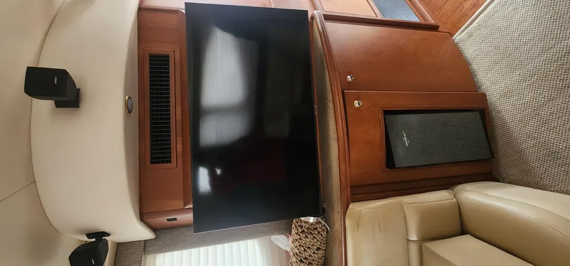  Yacht Photos Pics Interior of 2004 Silverton 48 Convertible yacht with TV and beige seating.