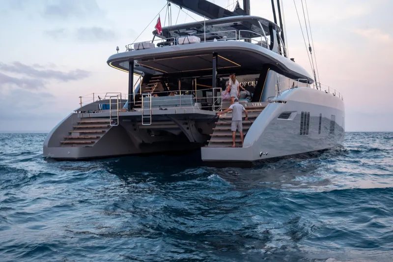 Shades Of Grey Yacht Photos Pics 2024 Sunreef 80 sailing yacht on open sea at sunset.