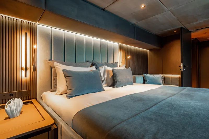 Shades Of Grey Yacht Photos Pics Luxurious bedroom interior of 2024 Sunreef 80 sailing yacht with modern design and ambient lighting.