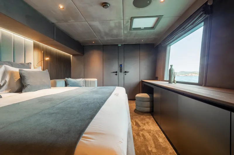 Shades Of Grey Yacht Photos Pics Luxurious bedroom interior of 2024 Sunreef 80 sailing yacht with ocean view.