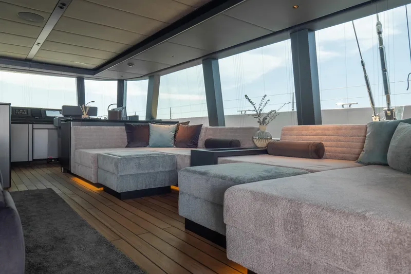 Shades Of Grey Yacht Photos Pics Luxurious interior of 2024 Sunreef 80 sailing yacht with modern seating and decor.