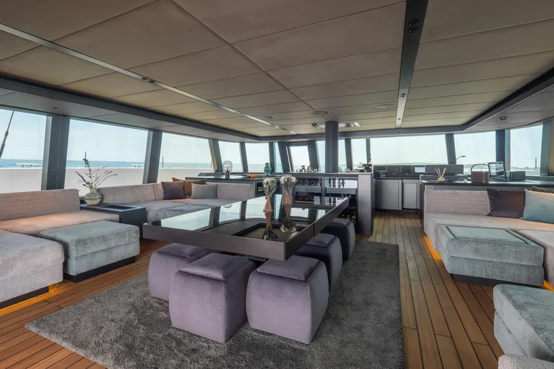 Shades Of Grey Yacht Photos Pics Luxurious interior of 2024 Sunreef 80 sailing yacht with modern furnishings and panoramic windows.