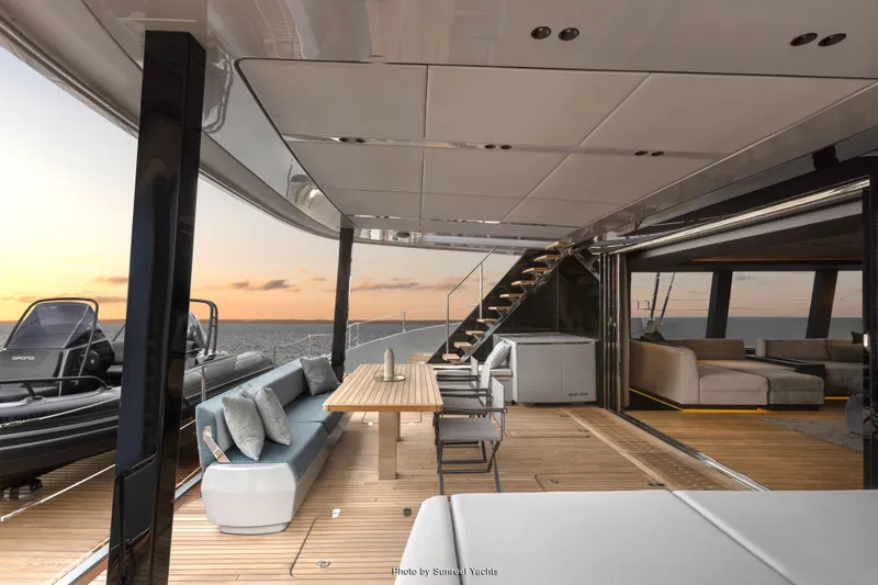 Shades Of Grey Yacht Photos Pics Luxurious Sunreef 80 sailing yacht interior, 2024 model, featuring elegant seating and sunset views.