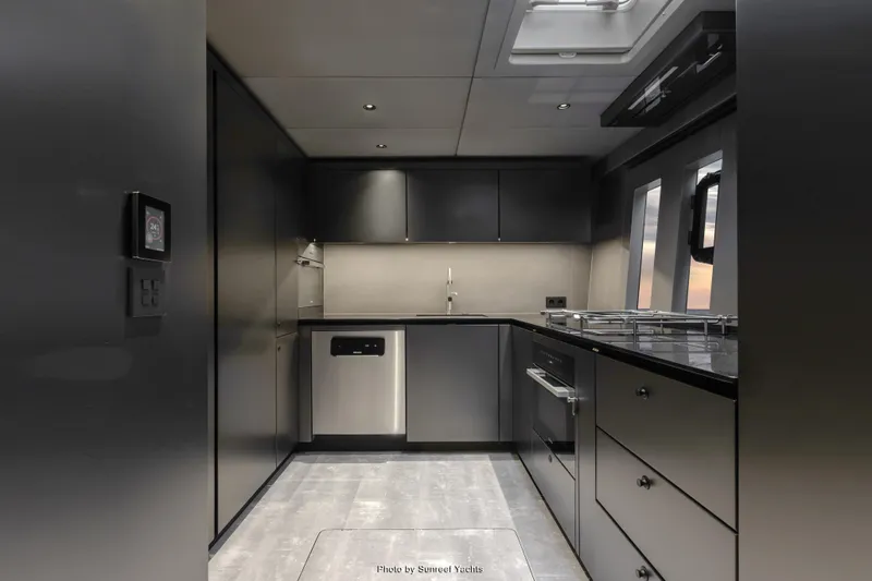 Shades Of Grey Yacht Photos Pics Modern kitchen interior of 2024 Sunreef 80 Sailing yacht, featuring sleek cabinetry and appliances.