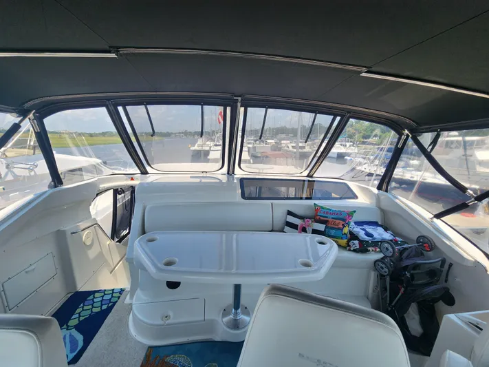 Nacho Boat Yacht Photos Pics Interior of 2000 Silverton 453 Motor Yacht with seating and table, docked at marina.