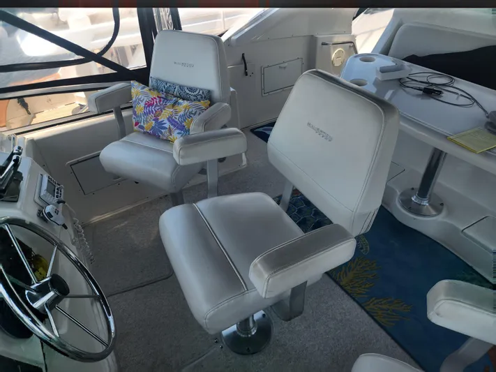 Nacho Boat Yacht Photos Pics Interior of 2000 Silverton 453 Motor Yacht with plush seating and steering wheel.