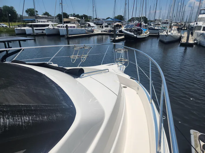 Nacho Boat Yacht Photos Pics 2000 Silverton 453 Motor Yacht docked in a marina, surrounded by sailboats.