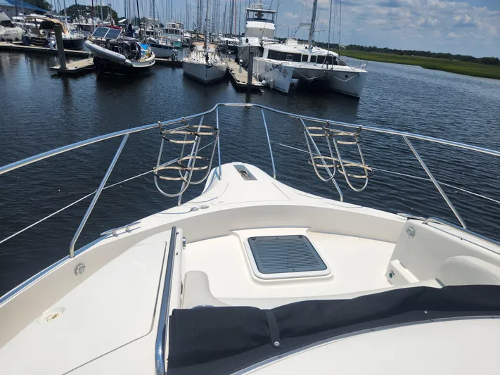 Nacho Boat Yacht Photos Pics 2000 Silverton 453 Motor Yacht docked at marina, surrounded by other boats.