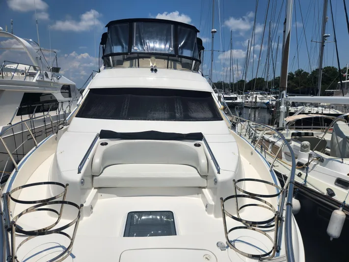 Nacho Boat Yacht Photos Pics 2000 Silverton 453 Motor Yacht docked at marina under clear blue sky.
