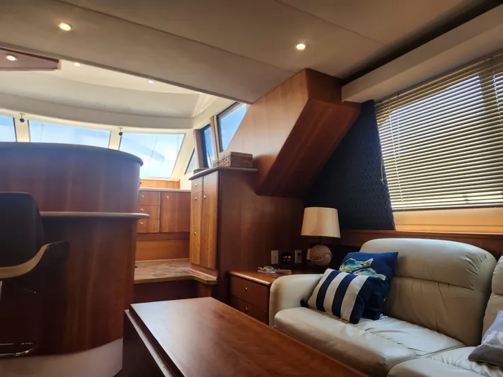 Nacho Boat Yacht Photos Pics Interior of 2000 Silverton 453 Motor Yacht with cozy seating and wooden cabinetry.