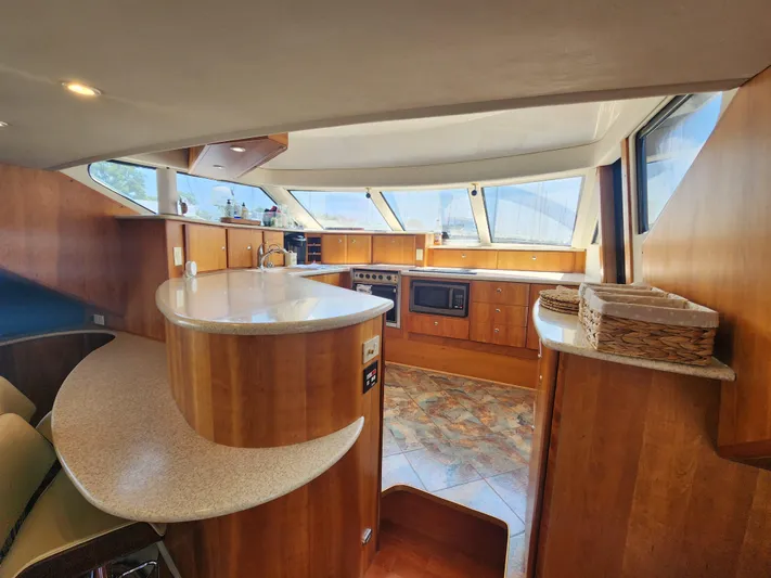 Nacho Boat Yacht Photos Pics Interior of 2000 Silverton 453 Motor Yacht with modern kitchen and wooden cabinetry.