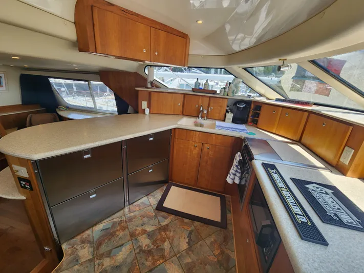 Nacho Boat Yacht Photos Pics Interior of 2000 Silverton 453 Motor Yacht with modern kitchen and wooden cabinetry.