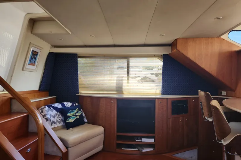 Nacho Boat Yacht Photos Pics Interior of 2000 Silverton 453 Motor Yacht with cozy seating and wooden cabinetry.
