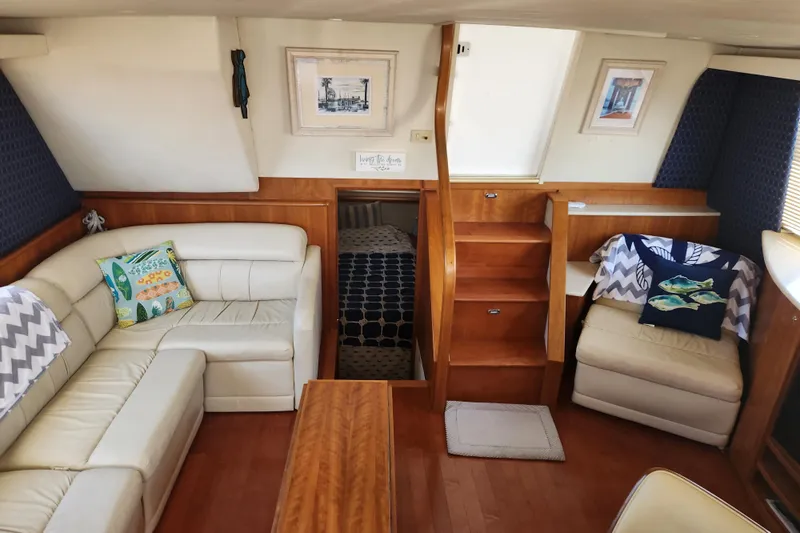 Nacho Boat Yacht Photos Pics Interior of 2000 Silverton 453 Motor Yacht with cozy seating and wooden accents.