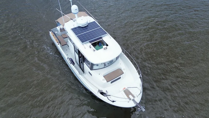 Inspector Gadget Yacht Photos Pics 2016 Jeanneau Merry Fisher 855 Marlin boat with solar panels on water.