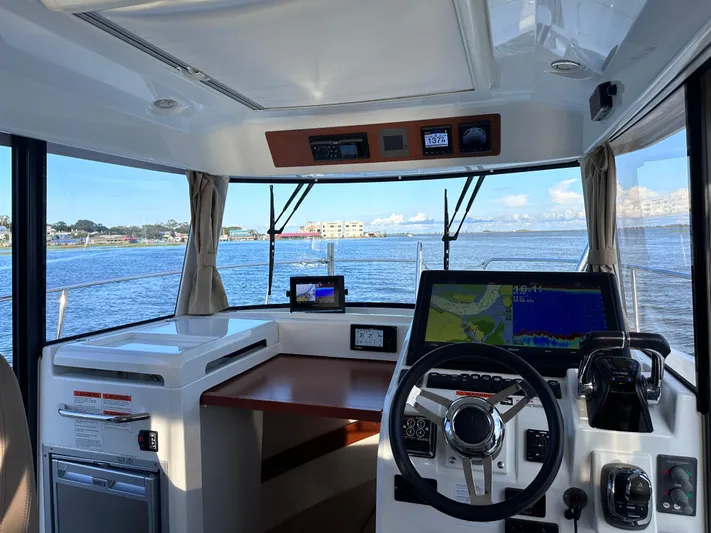 Inspector Gadget Yacht Photos Pics Interior view of 2016 Jeanneau Merry Fisher 855 Marlin boat cockpit with navigation equipment.