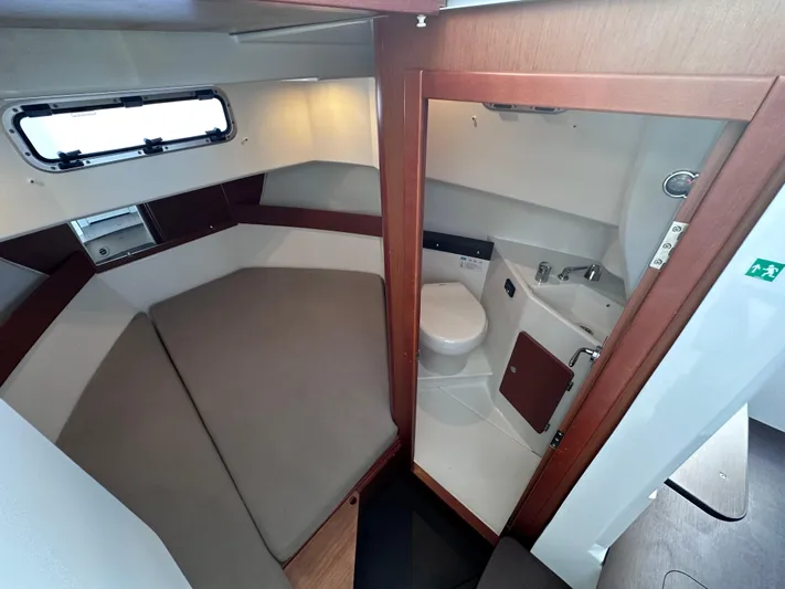 Inspector Gadget Yacht Photos Pics 2016 Jeanneau Merry Fisher 855 Marlin cabin interior with bed and compact bathroom.