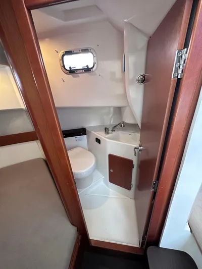 Inspector Gadget Yacht Photos Pics Compact bathroom in 2016 Jeanneau Merry Fisher 855 Marlin boat, featuring toilet and sink.