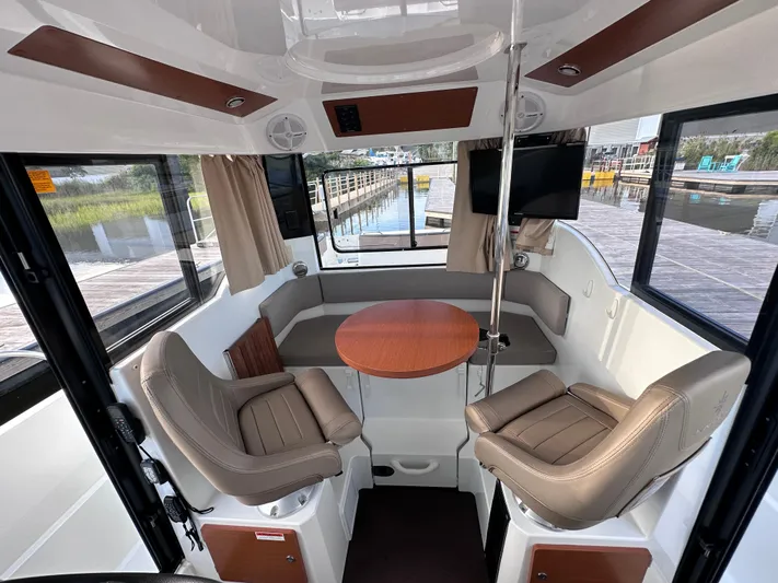 Inspector Gadget Yacht Photos Pics Interior of 2016 Jeanneau Merry Fisher 855 Marlin with seating and table.