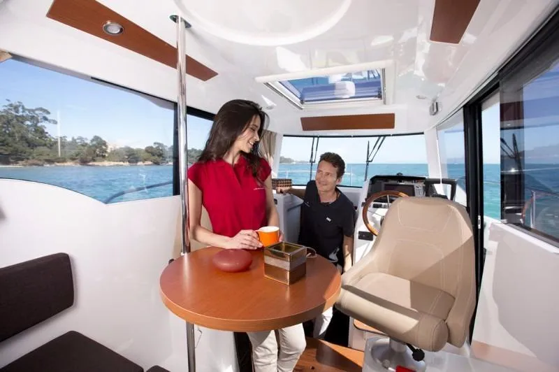 Inspector Gadget Yacht Photos Pics Couple enjoying coffee inside a 2016 Jeanneau Merry Fisher 855 Marlin boat.