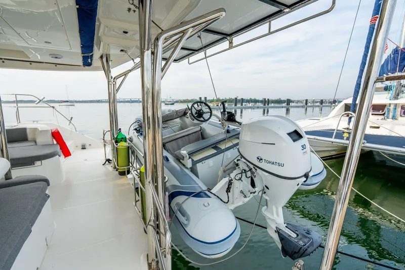 Grace Yacht Photos Pics Leopard 48 yacht deck with Tohatsu motorboat, 2016 model, docked in marina.
