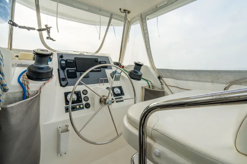 Grace Yacht Photos Pics Interior view of 2016 Leopard 48 yacht helm with steering wheel and navigation controls.