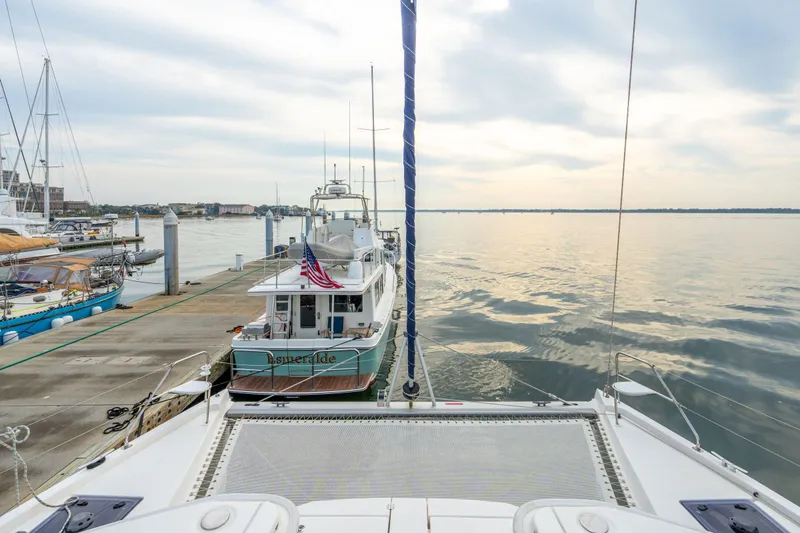Grace Yacht Photos Pics 2016 Leopard 48 yacht docked at marina with calm waters and cloudy sky.