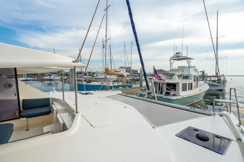 Grace Yacht Photos Pics 2016 Leopard 48 yacht docked in a marina with other boats under a cloudy sky.