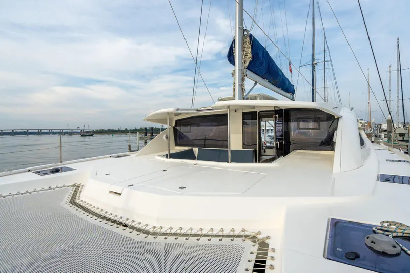 Grace Yacht Photos Pics 2016 Leopard 48 yacht with spacious deck and blue sail, docked at marina.