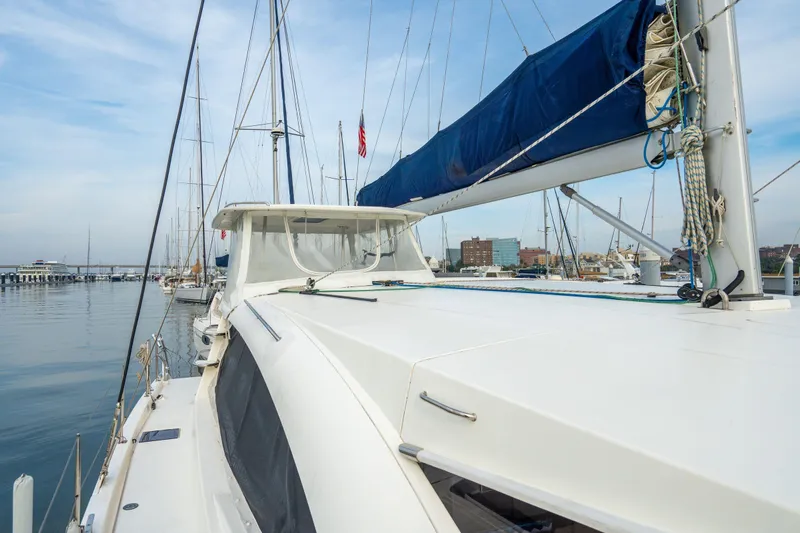 Grace Yacht Photos Pics 2016 Leopard 48 yacht docked at marina, featuring sleek design and blue sail cover.