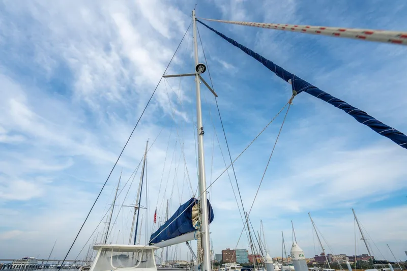 Grace Yacht Photos Pics Sailboat mast of 2016 Leopard 48 against a clear blue sky in a marina.