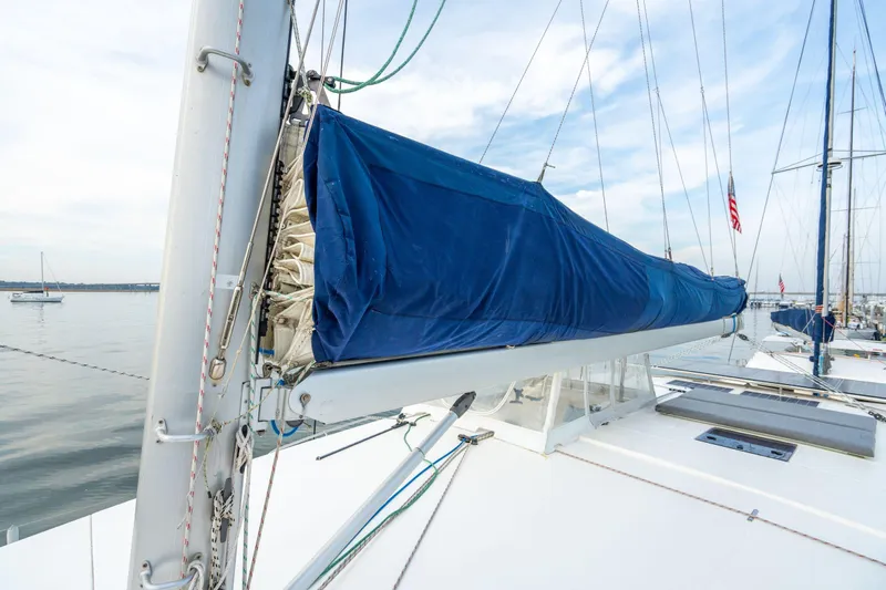 Grace Yacht Photos Pics 2016 Leopard 48 sailboat with blue sail cover, docked in calm waters.
