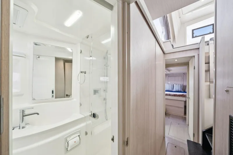 Grace Yacht Photos Pics Luxurious interior of 2016 Leopard 48 yacht featuring modern bathroom and cozy bedroom.