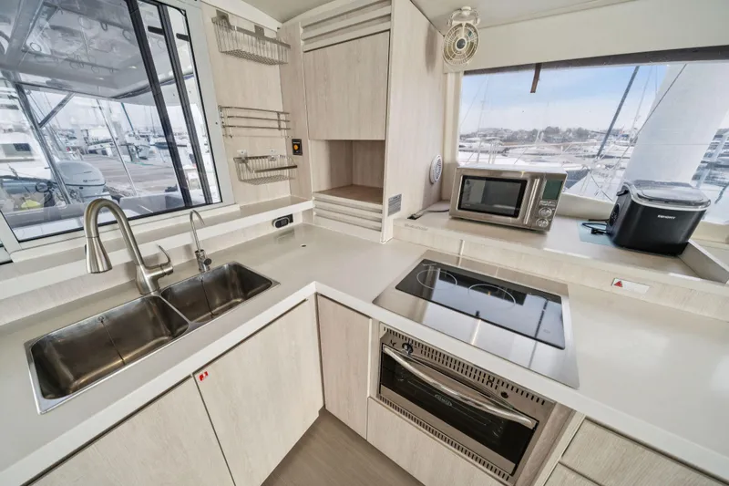 Grace Yacht Photos Pics Modern kitchen in 2016 Leopard 48 yacht with appliances and marina view.