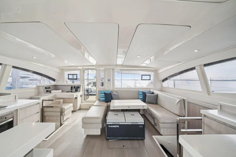 Grace Yacht Photos Pics Luxurious interior of a 2016 Leopard 48 yacht with modern seating and panoramic windows.