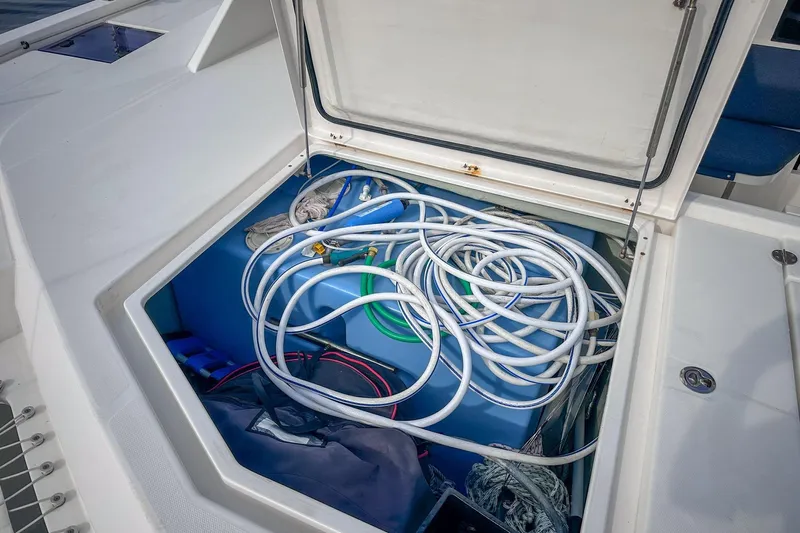 Grace Yacht Photos Pics Open storage compartment on 2016 Leopard 48 yacht with coiled hoses and equipment.