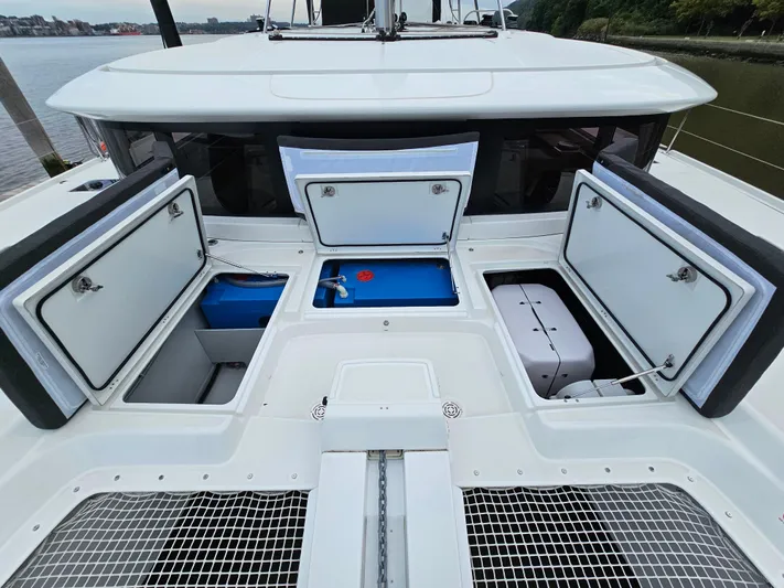  Yacht Photos Pics 2024 Lagoon 46 yacht with open storage compartments on deck.