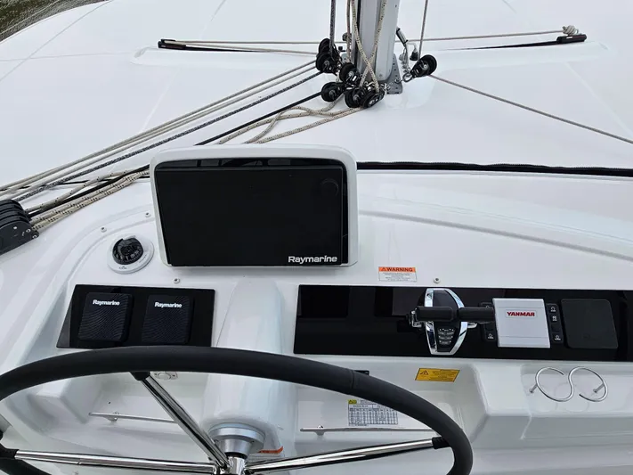  Yacht Photos Pics 2024 Lagoon 46 yacht helm with Raymarine navigation system and Yanmar controls.