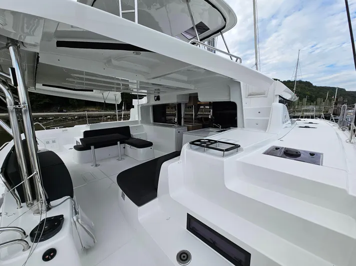  Yacht Photos Pics 2024 Lagoon 46 yacht with spacious deck and modern seating.