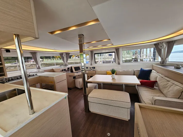  Yacht Photos Pics Luxurious interior of 2024 Lagoon 46 catamaran with modern furnishings and ample natural light.