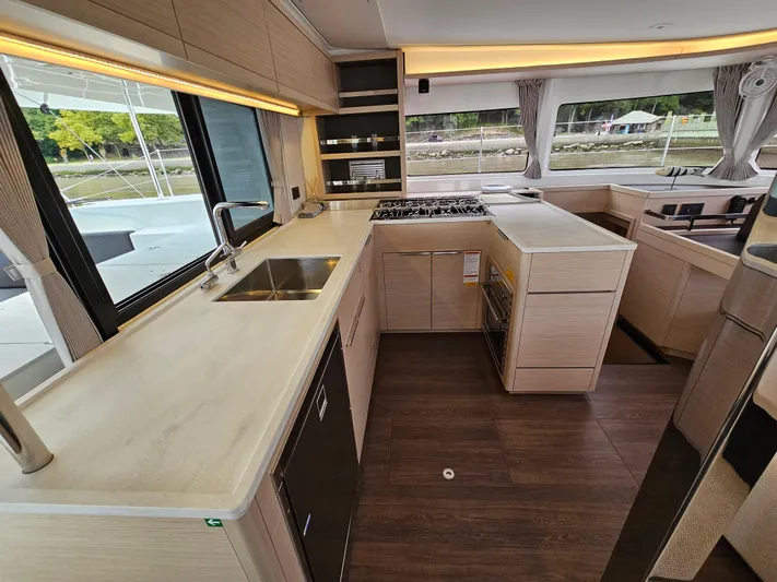  Yacht Photos Pics Modern kitchen interior of 2024 Lagoon 46 yacht with sleek countertops and appliances.