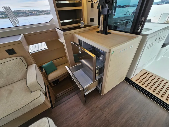  Yacht Photos Pics Luxurious interior of 2024 Lagoon 46 yacht with modern cabinetry and seating.