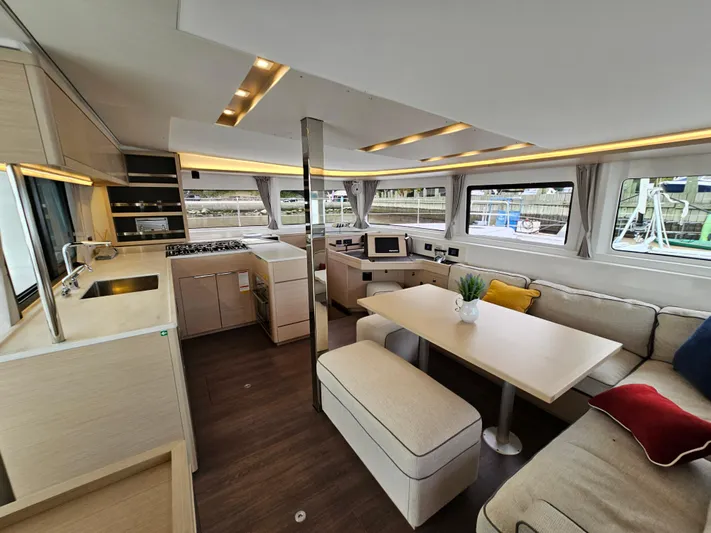  Yacht Photos Pics Luxurious interior of 2024 Lagoon 46 catamaran with modern kitchen and spacious seating area.
