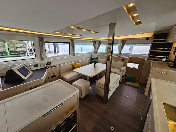 Yacht Photos Pics Luxurious interior of 2024 Lagoon 46 catamaran with modern furnishings and panoramic windows.