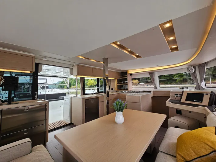  Yacht Photos Pics Luxurious interior of 2024 Lagoon 46 yacht with modern kitchen and dining area.