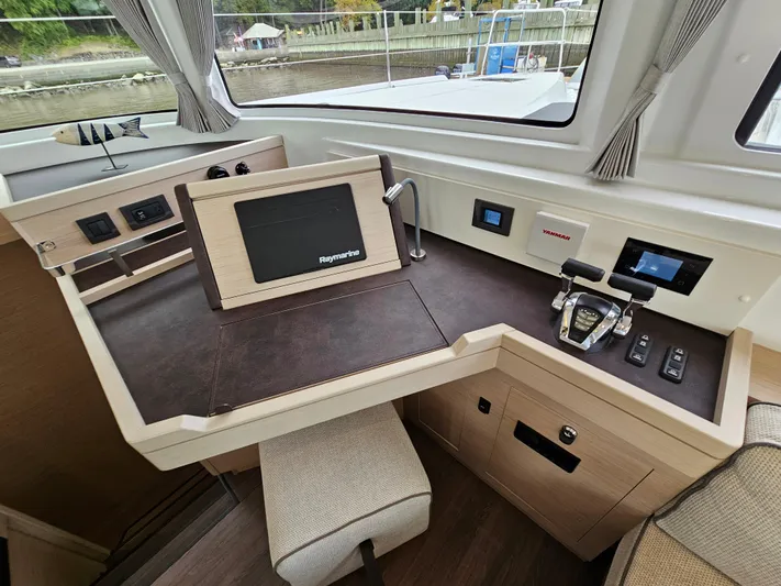  Yacht Photos Pics 2024 Lagoon 46 yacht helm station with navigation controls and modern dashboard.