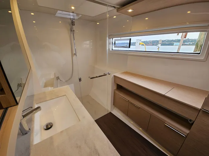  Yacht Photos Pics Modern bathroom in 2024 Lagoon 46 yacht with sleek design and ample storage.