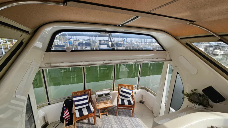 Ada Yacht Photos Pics Interior of 2002 Carver 396 Motor Yacht with seating and marina view.